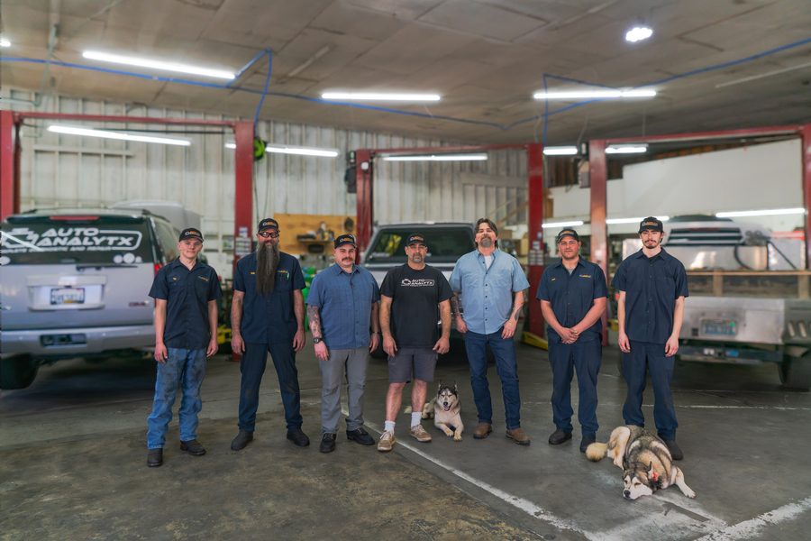 The seven-person Auto Analytx team standing in the service bays at their Auburn, CA facility