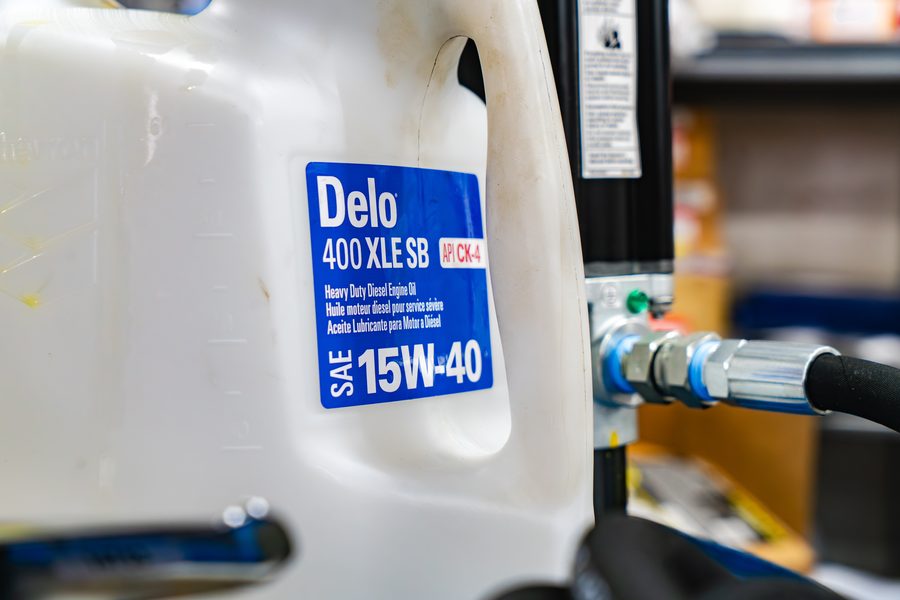 Bulk drum of Delo 400 XLE 15W-40 heavy duty diesel engine oil with dispensing hose