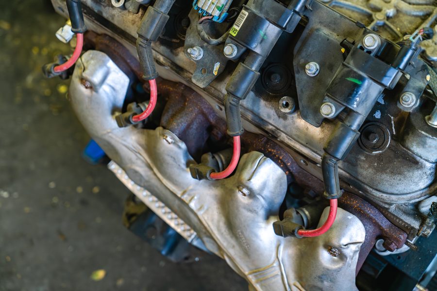 Exhaust manifolds and ignition wires along the cylinder head of a V8 engine