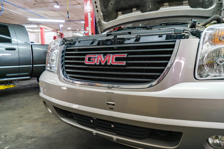 GMC Yukon in the Auto Analytx workshop with the hood raised for service