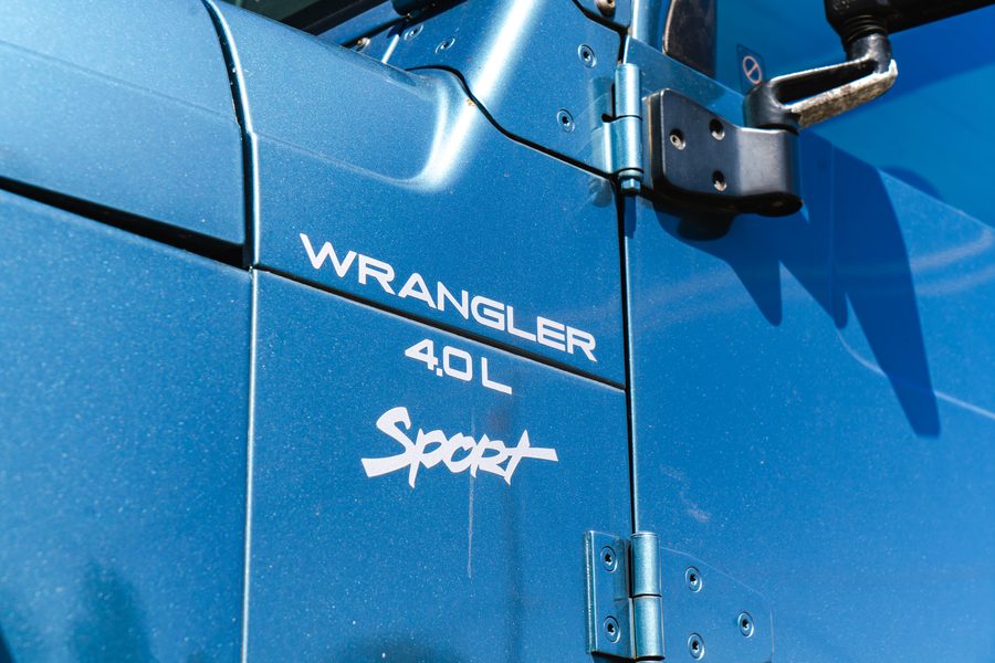 Wrangler 4.0L Sport badge on the fender of a blue Jeep