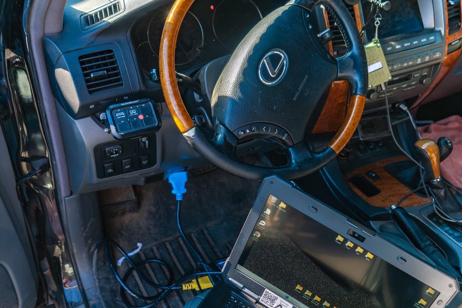 Diagnostic laptop connected to the OBD port of a Lexus in for service